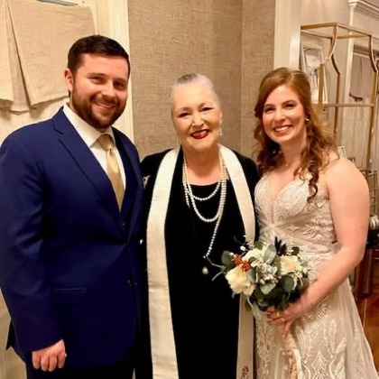 Sarah with a couple after their ceremony