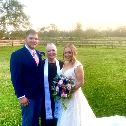 Sarah with a couple in a sunlit pasture