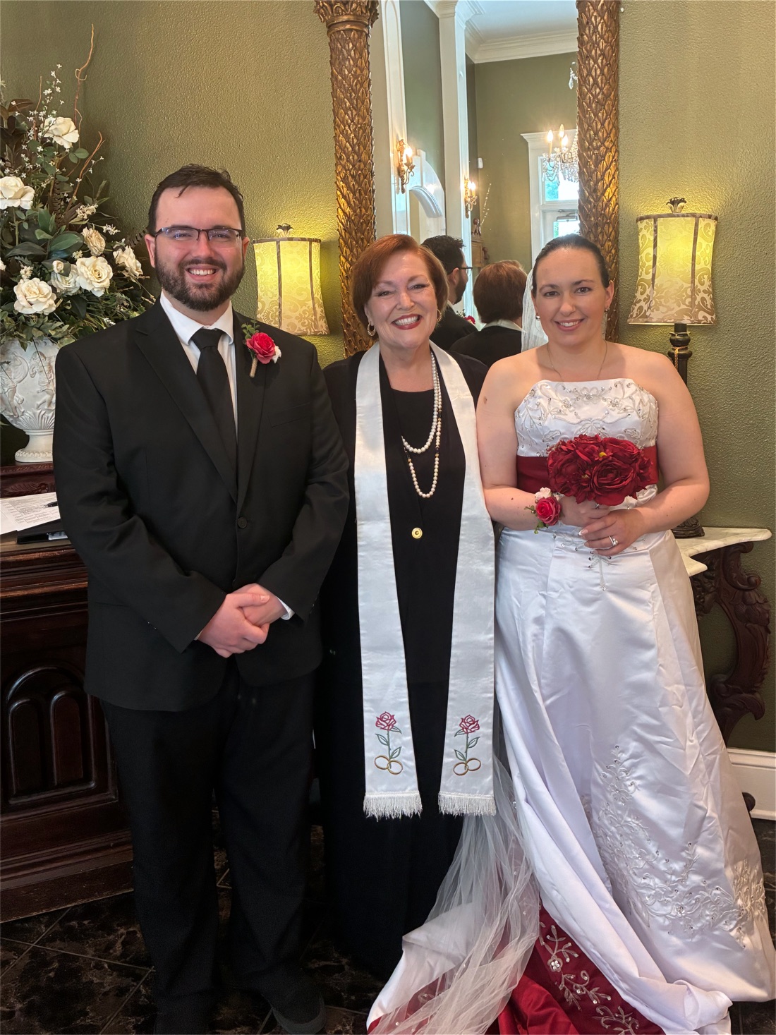 Rev. Sarah Corie with a bride and groom after their ceremony